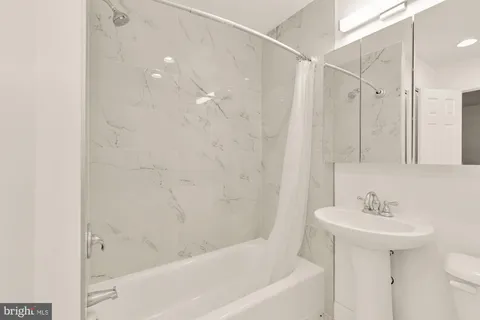 a bathroom with a bathtub and a sink