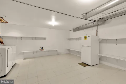 a view of a storage & utility room with racks on the wall