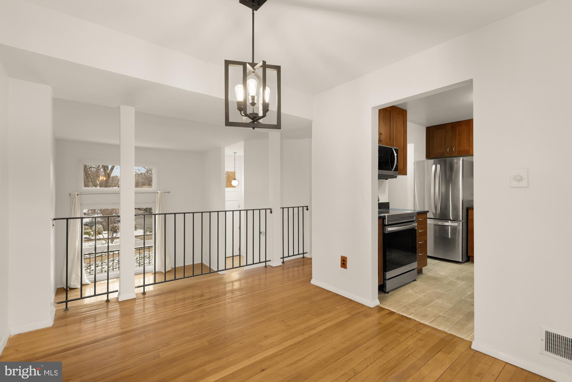 7149 Mill Run Drive, Unit 155 Rockville, MD 20855 - Photo 7 of 22 a view of a hallway with wooden floor and chandelier