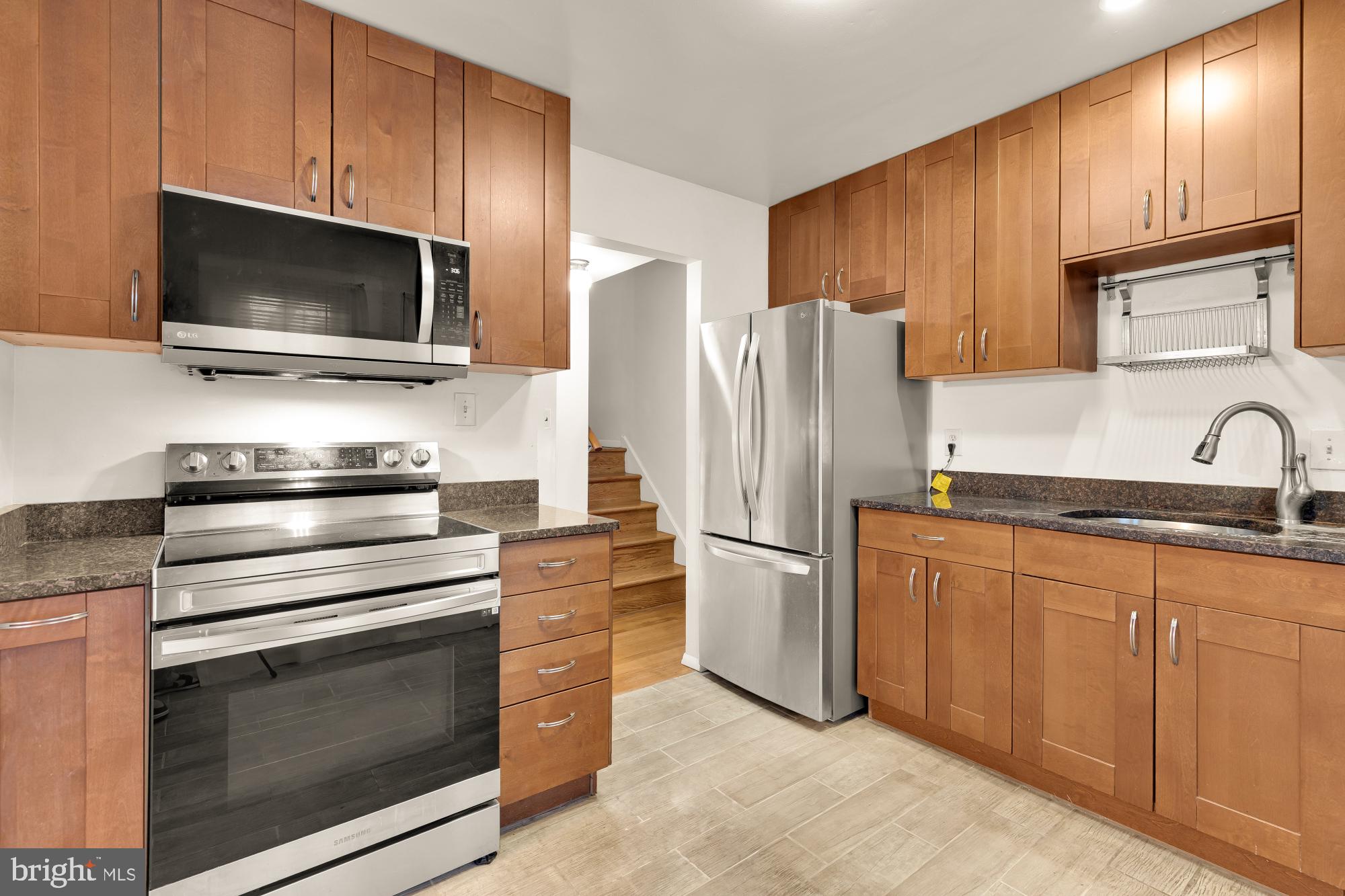 7149 Mill Run Drive, Unit 155 Rockville, MD 20855 - Photo 9 of 22 a kitchen with granite countertop cabinets stainless steel appliances and a sink