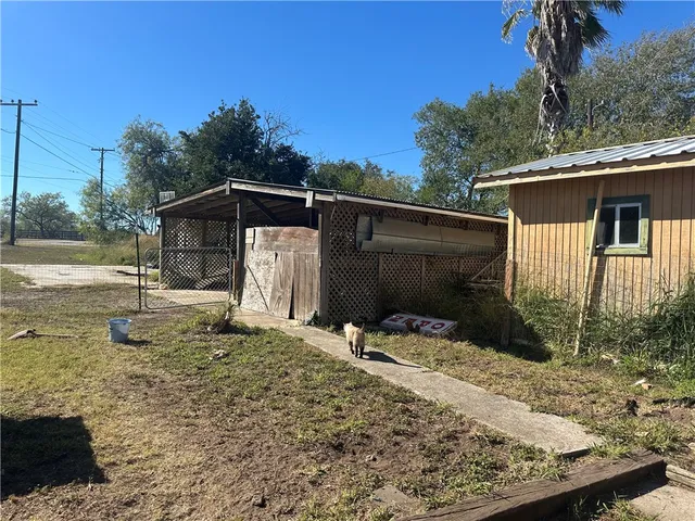 a backyard of a house with barbeque oven