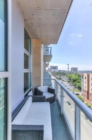 a large living room with stainless steel appliances granite countertop furniture and a kitchen view
