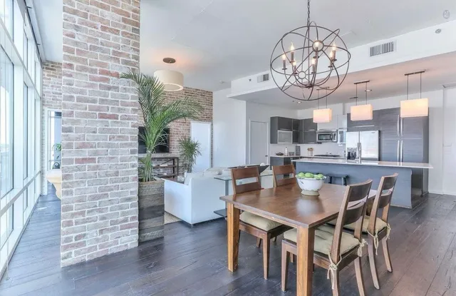 a view of a dining room with furniture wooden floor and chandelier