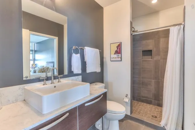 a bathroom with a sink toilet and shower