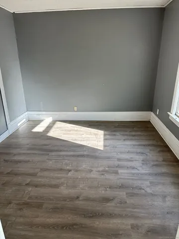 a view of an empty room and wooden floor