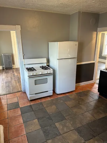 a kitchen with a stove top oven and cabinets