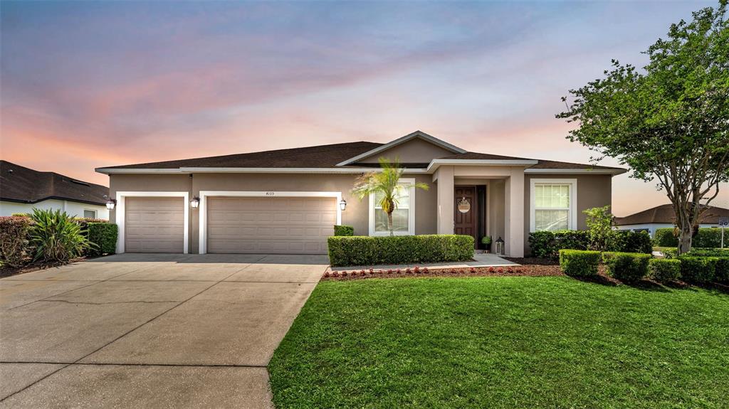 4105 Berkshire Loop Lakeland, FL 33813 - Photo 1 of 41 a front view of a house with a yard and garage