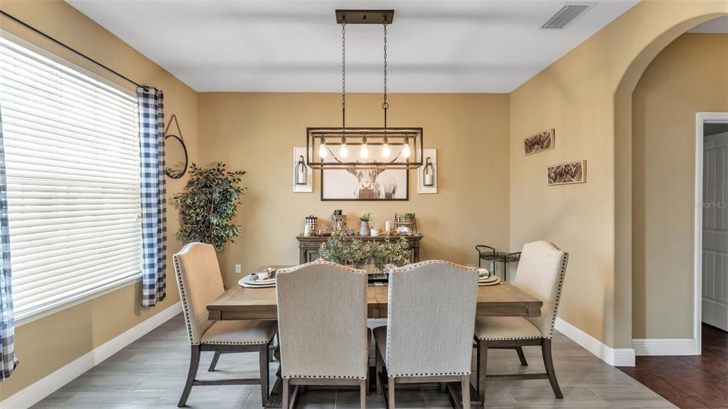 4105 Berkshire Loop Lakeland, FL 33813 - Photo 12 of 41 a view of a dining room with furniture window and wooden floor