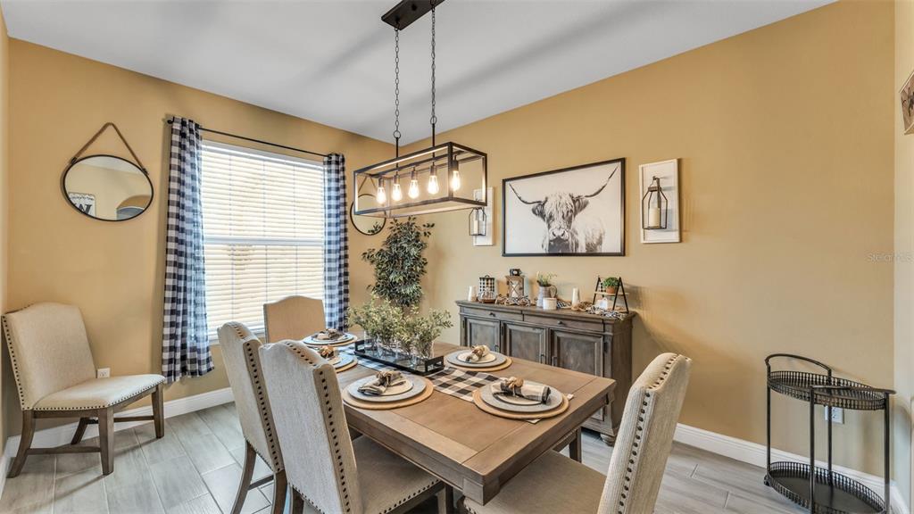 4105 Berkshire Loop Lakeland, FL 33813 - Photo 13 of 41 a view of a dining room with furniture window and wooden floor