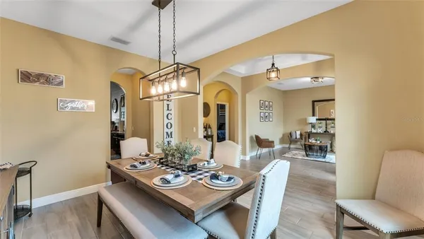 a view of a dining room with furniture and wooden floor