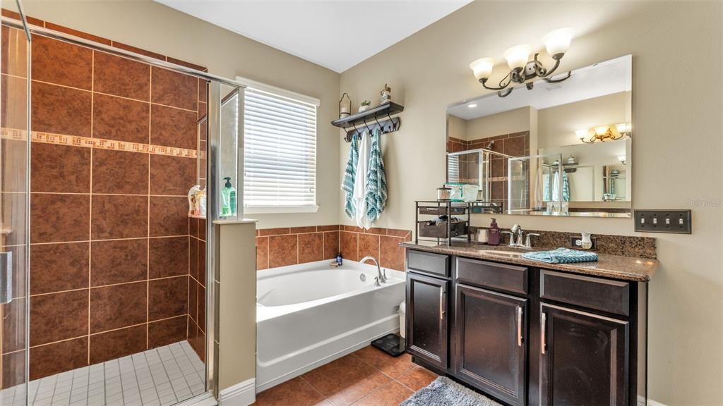 4105 Berkshire Loop Lakeland, FL 33813 - Photo 26 of 41 a bathroom with a tub sink and mirror