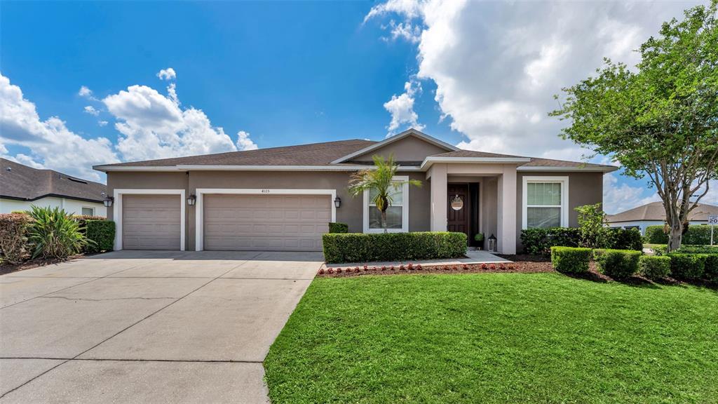 4105 Berkshire Loop Lakeland, FL 33813 - Photo 33 of 41 a front view of a house with a yard and garage