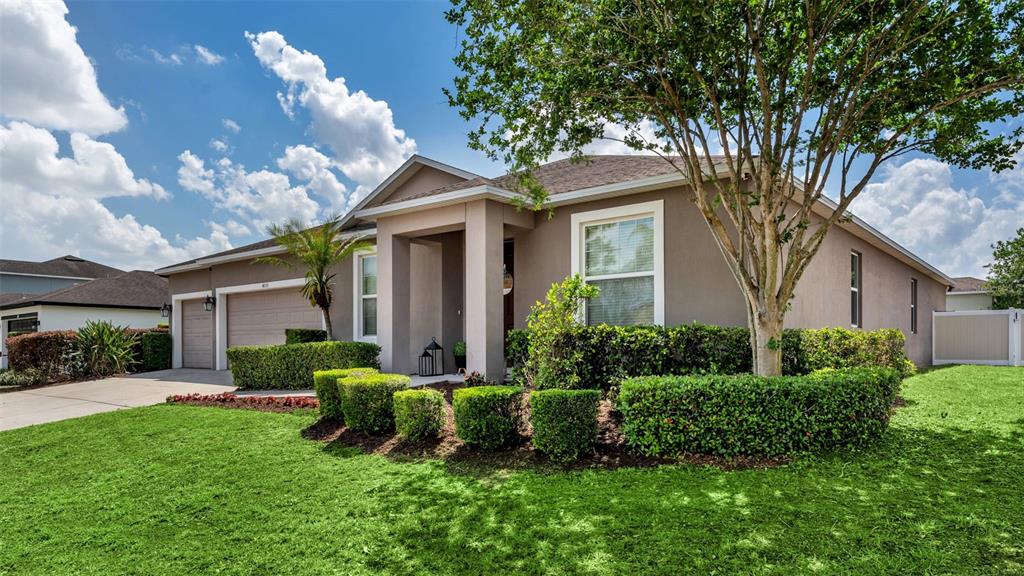 4105 Berkshire Loop Lakeland, FL 33813 - Photo 34 of 41 a front view of a house with a yard and outdoor seating