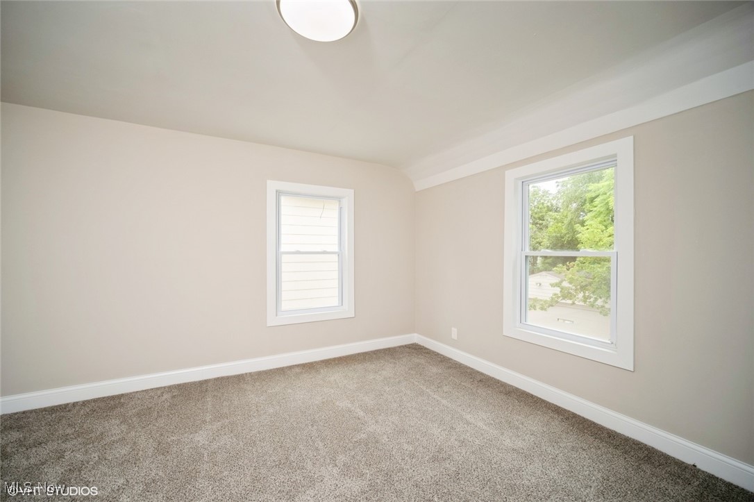 2188 North Taylor Road Cleveland Heights, OH 44112 - Photo 12 of 15 Spare room with carpet floors, healthy amount of natural light, and vaulted ceiling