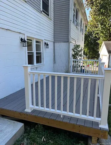 a view of a house with wooden fence