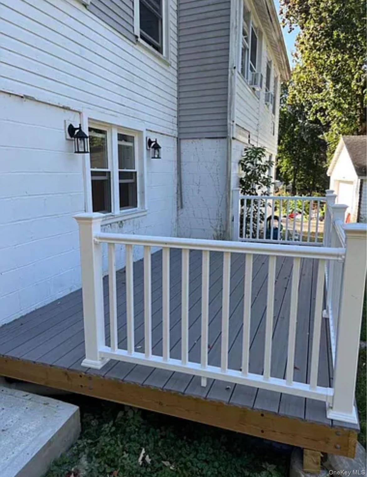 a view of a house with wooden fence