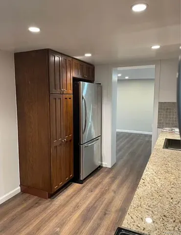 a view of a refrigerator in kitchen and wooden floor