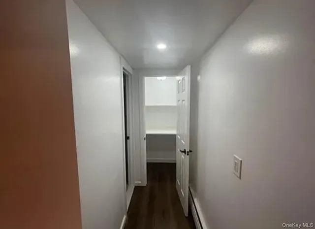 a view of a hallway with a room