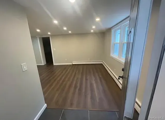 wooden floor in an empty room with a mirror