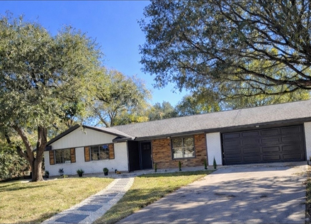 a front view of a house with a yard covered in snow