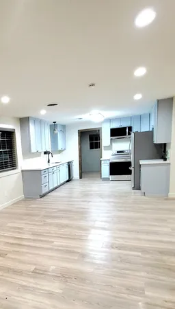 a view of kitchen with stainless steel appliances kitchen island