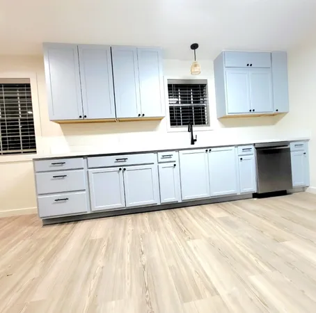 a kitchen with granite countertop a stove a sink and a microwave