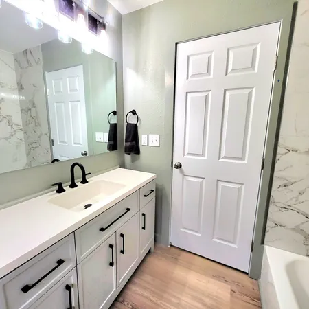 a bathroom with a double vanity sink and a mirror