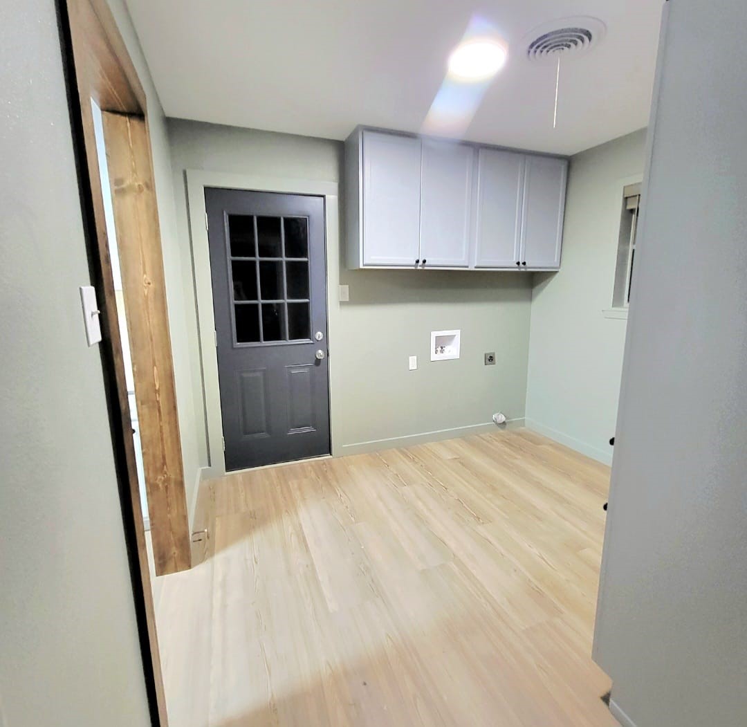 1608 Longhofer Street Brenham, TX 77833 - Photo 20 of 24 an empty room with a window and wooden floor