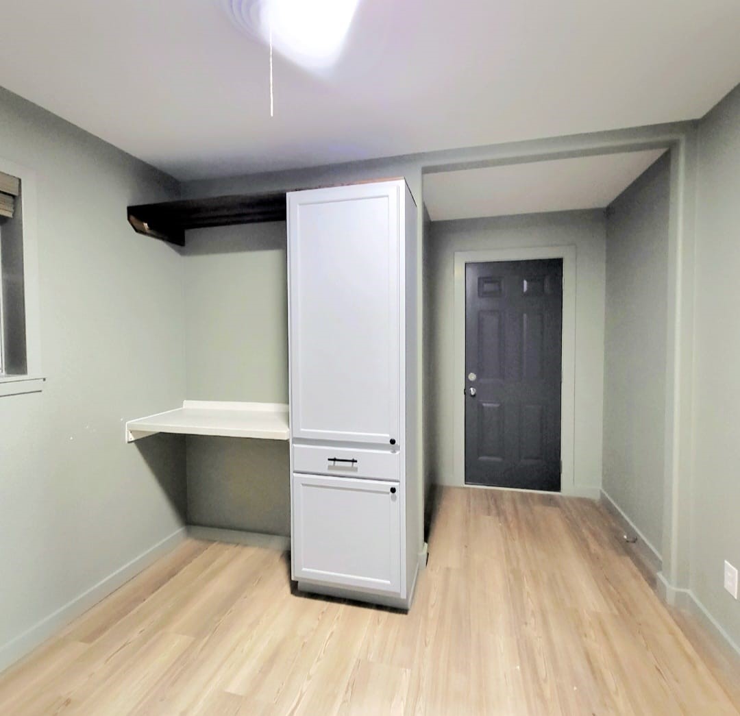 1608 Longhofer Street Brenham, TX 77833 - Photo 21 of 24 a room with wooden floor and cabinet