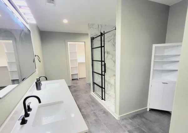 a en suite bathroom with a sink and mirror