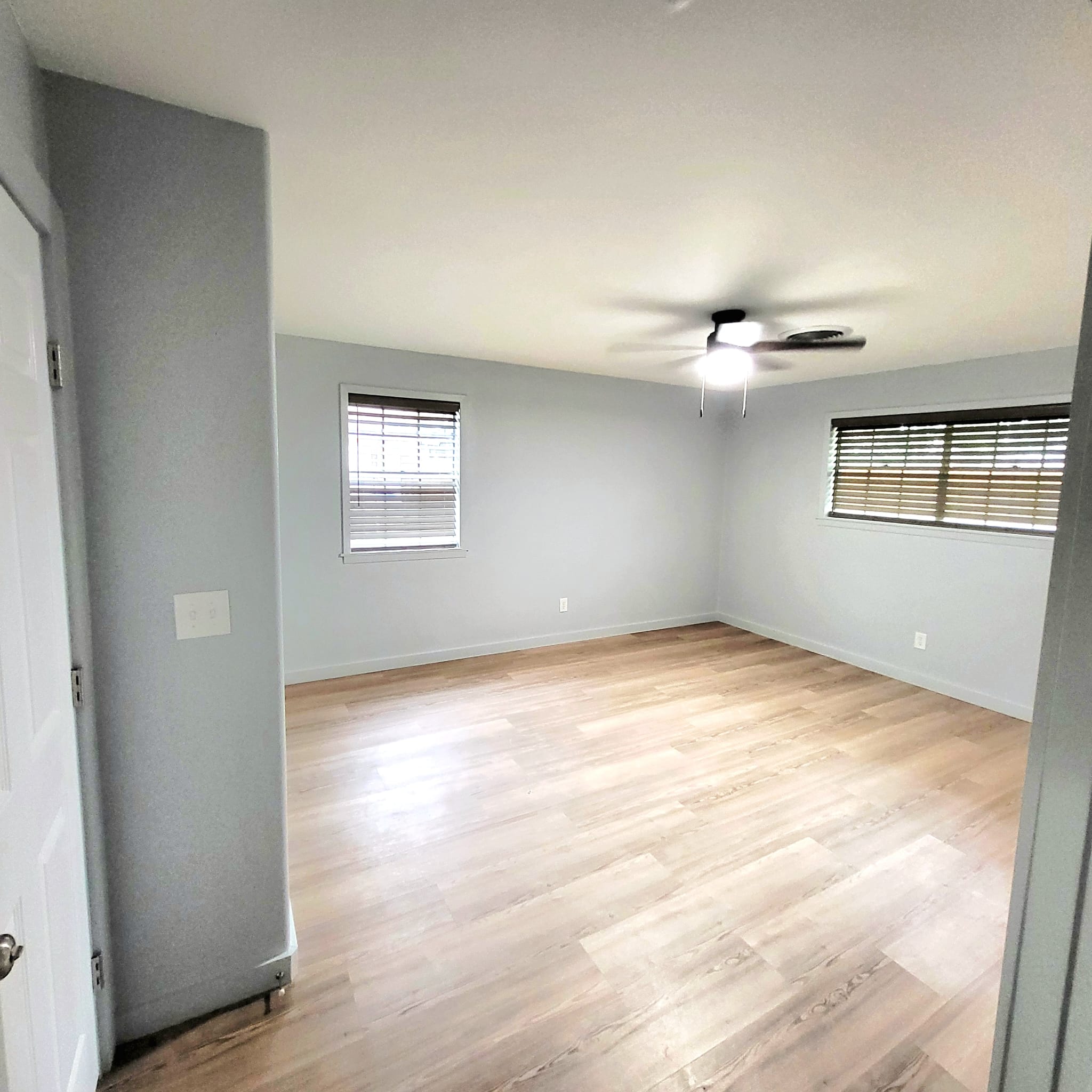 1608 Longhofer Street Brenham, TX 77833 - Photo 7 of 24 an empty room with wooden floor and windows