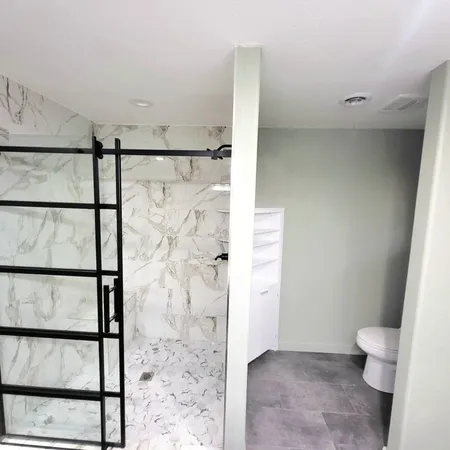 a bathroom with a shower toilet and sink