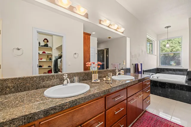 an empty room with windows and ceiling fan