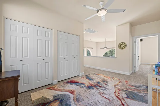 a living room with furniture a rug and a book shelf