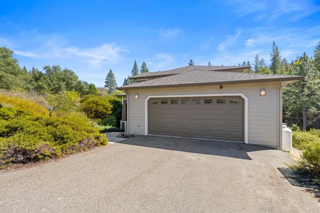 a front view of a house with plants