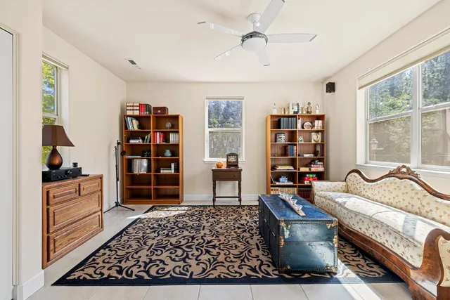 a view of backyard with a table and chairs and wooden fence