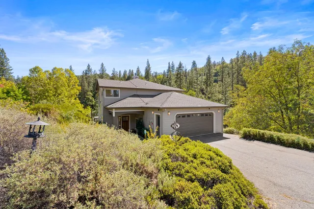 a kitchen with stainless steel appliances kitchen island granite countertop a stove a sink and a refrigerator