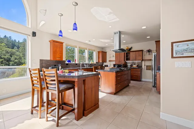 a bedroom with a bed and large windows