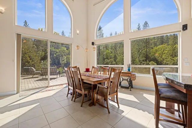 a view of an empty room with a window and a ceiling fan