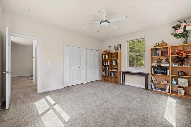 an empty room with windows and closet