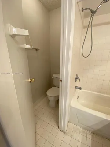 a bathroom with a sink a toilet a mirror and shower