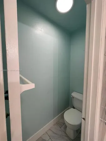 an empty room with wooden floor and window