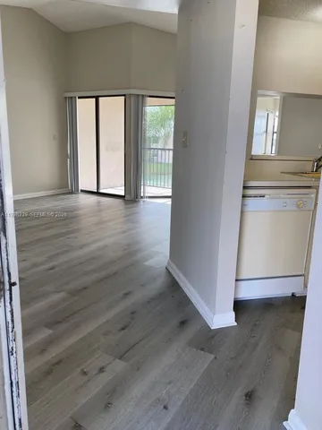 a view of wooden floor and windows in a room