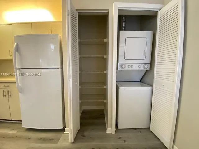 a kitchen with appliances a sink and cabinets