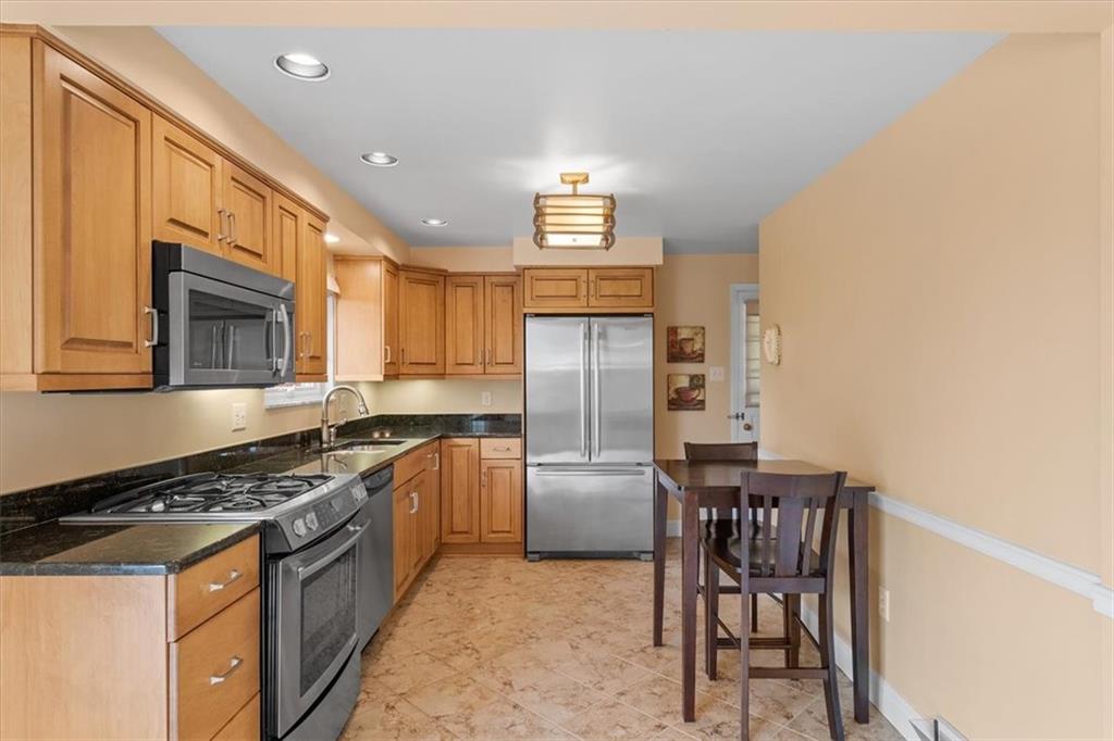 1020 Silver Lane McKees Rocks, PA 15136 - Photo 15 of 36 a kitchen with stainless steel appliances granite countertop a stove top oven a sink and a refrigerator