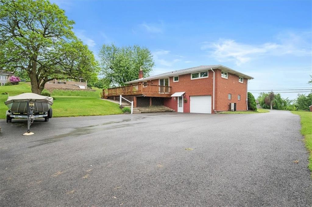 1020 Silver Lane McKees Rocks, PA 15136 - Photo 26 of 36 a front view of a house with a yard and garage