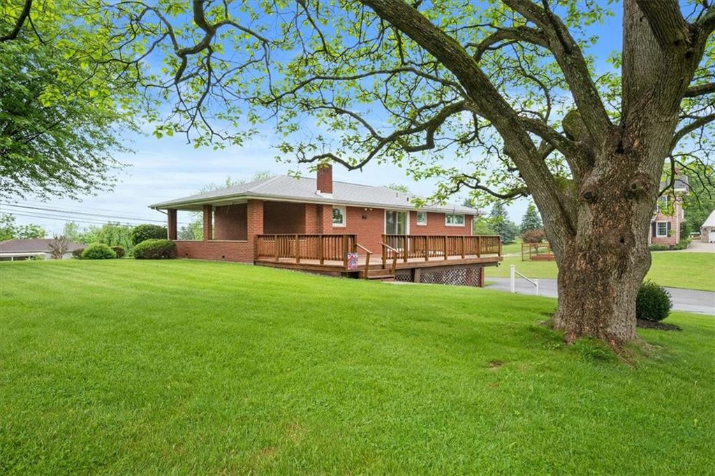 1020 Silver Lane McKees Rocks, PA 15136 - Photo 27 of 36 a view of house in front of a big yard with large trees and plants