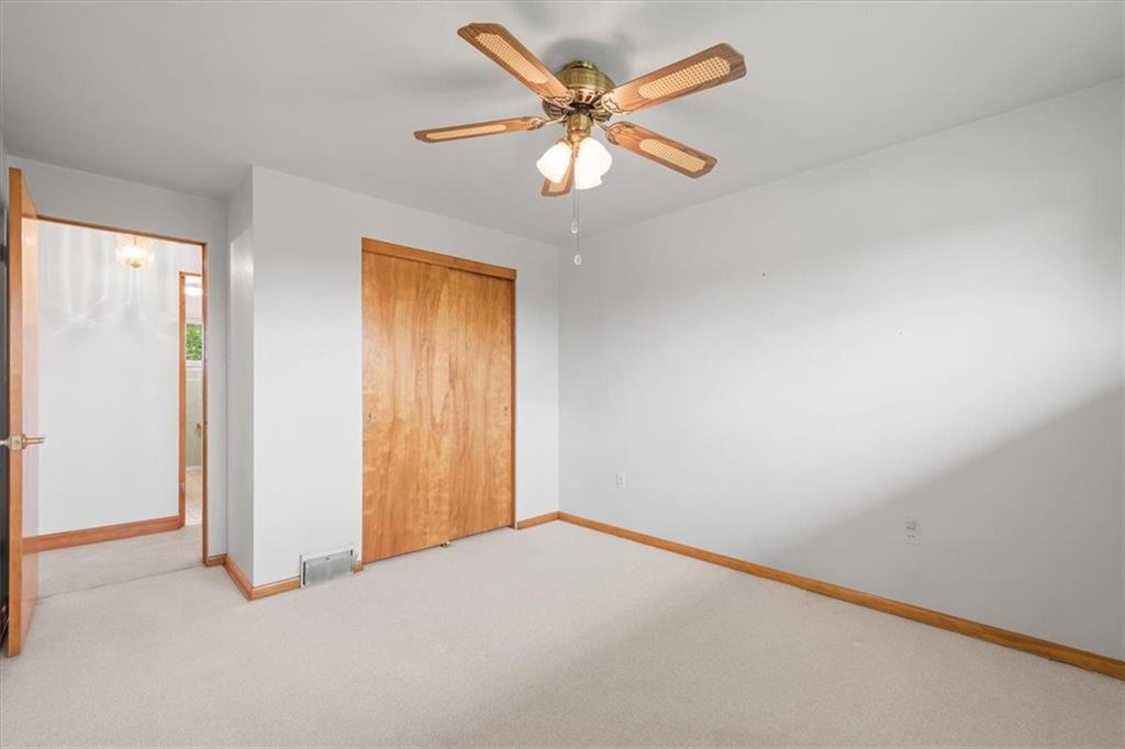 1020 Silver Lane McKees Rocks, PA 15136 - Photo 10 of 36 an empty room with a chandelier fan and windows
