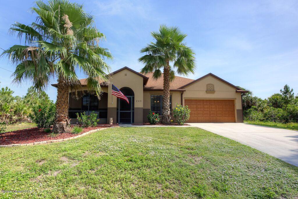 249 Franzing Street Palm Bay, FL 32908 - Photo 1 of 20 a front view of house with yard and green space