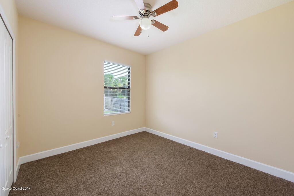 249 Franzing Street Palm Bay, FL 32908 - Photo 13 of 20 an empty room with a window and a fan